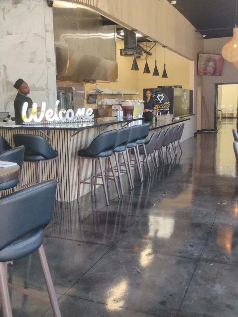 Lonell's bar with Welcome neon sign and seating