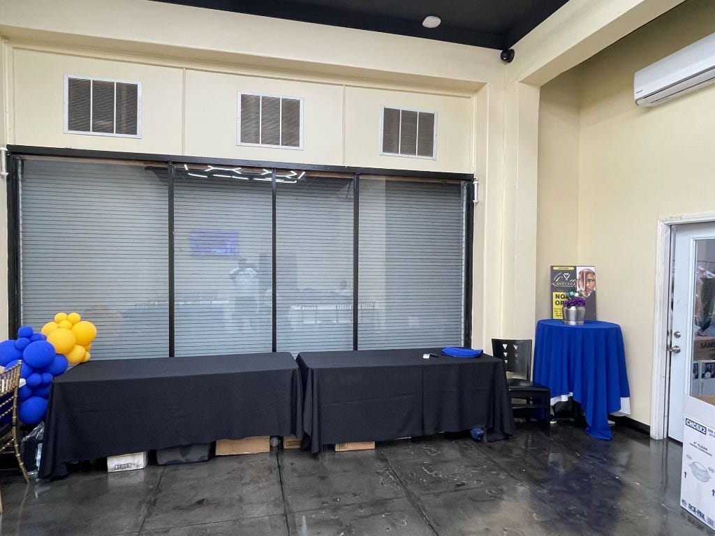 Event room setup with decorated tables and balloon display