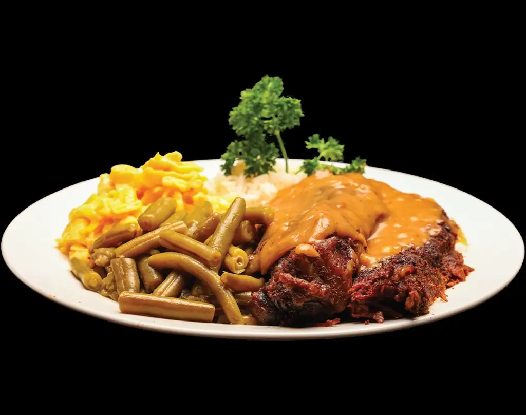 Homestyle meatloaf with savory gravy, green beans, mac and cheese, and rice at Lonell's Soul Food